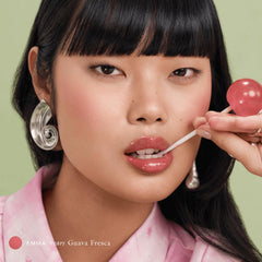 Applying EADEM Le Chouchou lip balm for overnight hydration.