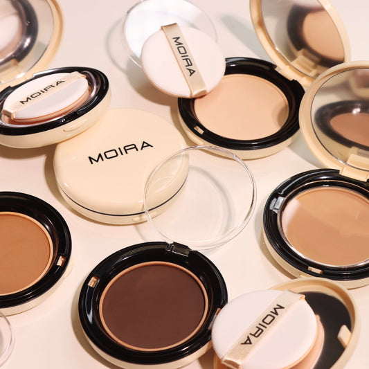 Moira Complete Wear powder foundation swatch with applicator showing buildable coverage.